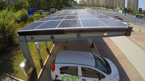 An electric car is being charged at a photovoltaic power carport in Shanghai, China, 17 August 2016.