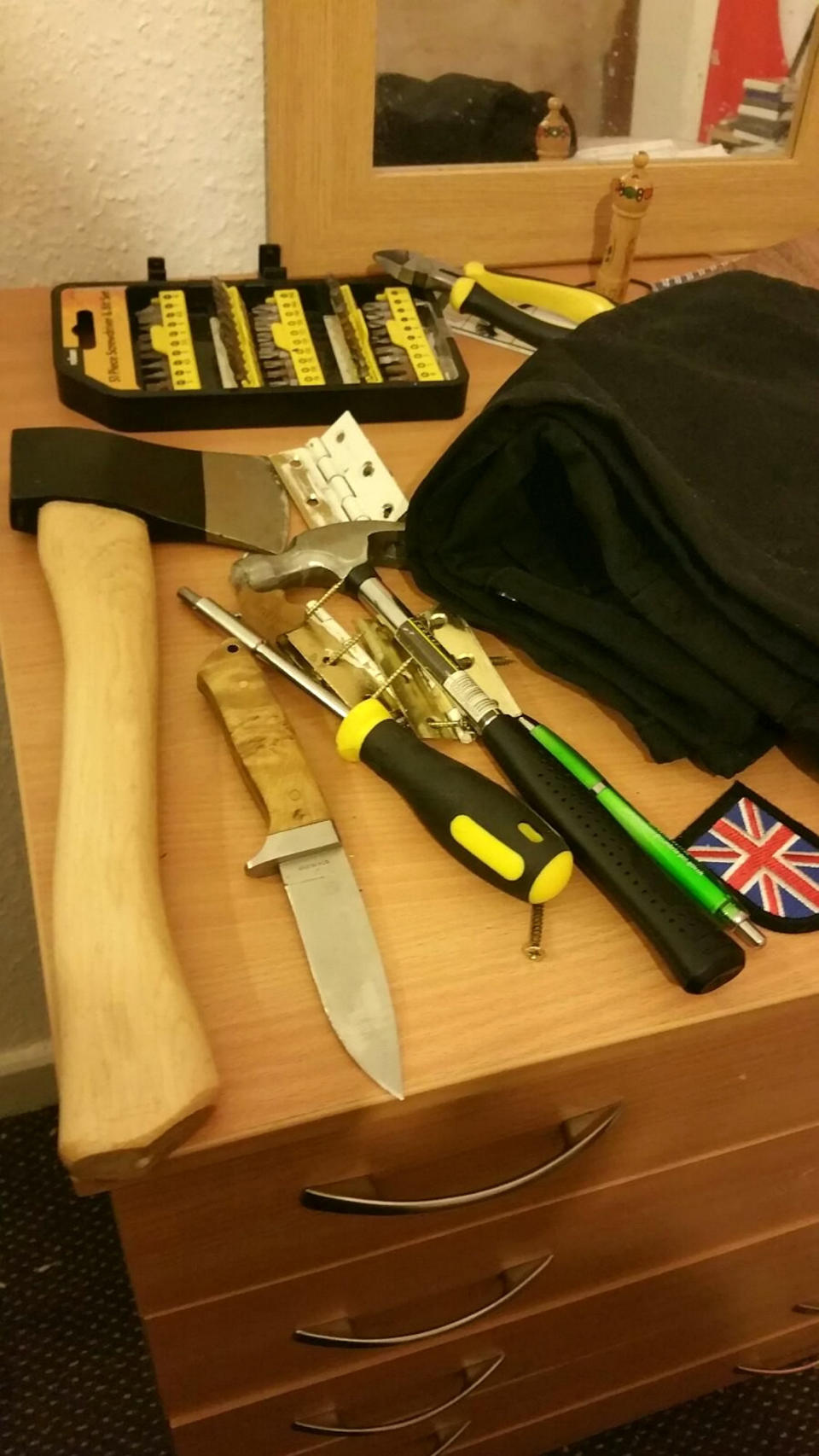 An axe, An axe, a knife and tools were found at Stables's home (Picture: SWNS)