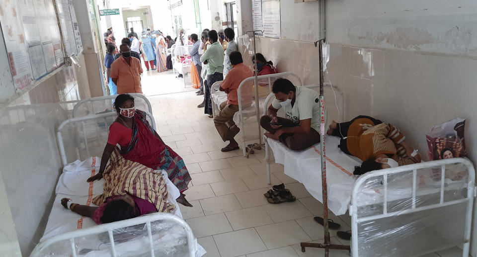Patients and their bystanders are seen at the district government hospital in Eluru, Andhra Pradesh state, India.