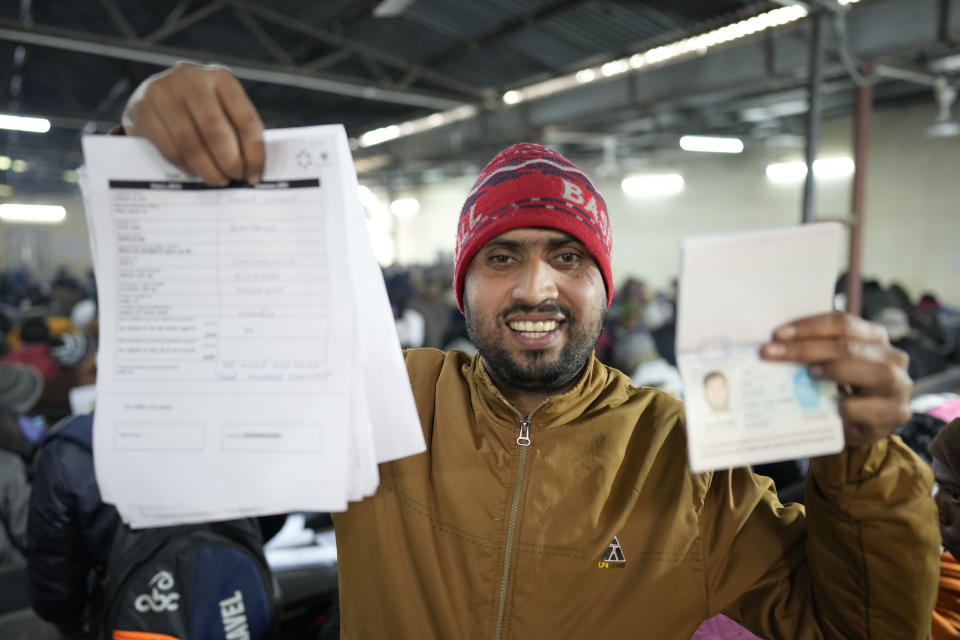 Anup Singh, an Indian skilled worker aspiring to be hired for a job in Israel shows his passport and a form he filled during a recruitment drive in Lucknow, India, Thursday, Jan. 25, 2024. (AP Photo/Rajesh Kumar Singh)