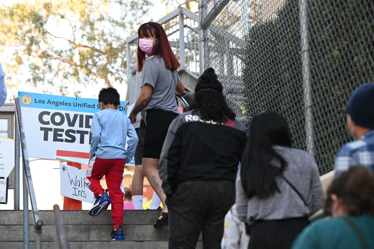 People lining up on the stairs at a school in Los Angeles.