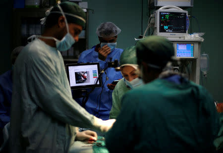 Palestinian surgeon Hafez Abu Khousa and his assistants are guided by doctor Ghassan Abu Sitta in Beirut during a Proximie surgery in the operating room at Al Awda Hospital in the northern Gaza Strip April 30, 2016. REUTERS/Suhaib Salem TPX IMAGES OF THE DAY