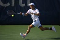 Kei Nishikori, of Japan, hits a running shot against Cameron Norrie, of Britain, during a match in the Citi Open tennis tournament, Thursday, Aug. 5, 2021, in Washington. (AP Photo/Nick Wass)