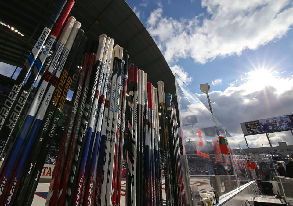 WINNIPEG, MB - OCTOBER 23: The Winnipeg Jets sticks lined up before they take on the Edmonton Oilers during the 2016 Tim Hortons NHL Heritage Classic alumni game at Investors Group Field on October 23, 2016 in Winnipeg, Canada. (Photo by Andre Ringuette/NHLI via Getty Images)