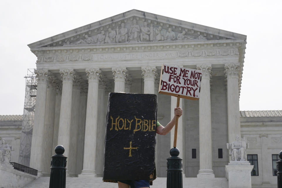 A person protests outside the Supreme Court, Friday, June 30, 2023, as decisions are expected in Washington. (AP Photo/Mariam Zuhaib)