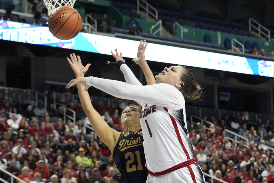 NC State's River Baldwin (1) shoots giants Notre Dame's Maddy Westbeld (21) during the first half of an NCAA basketball game for the Women's Atlantic Coast Conference championship in Greensboro, N.C., Sunday, March 10, 2024. (AP Photo/Chuck Burton)