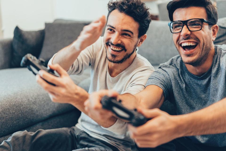excited friends playing video games