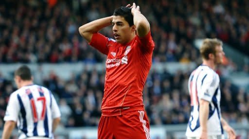 Liverpool's Uruguayan forward Luis Suarez reacts after missing an opportunity to score during the English Premier League football match between Liverpool and West Bromwich Albion at Anfield in Liverpool. West Brom won 1-0