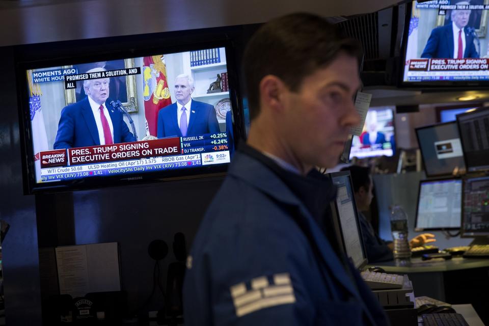 President Donald Trump is displayed on television monitors as traders work and financial professionals work on the floor of the New York Stock Exchange (NYSE). (Drew Angerer/Getty Images)