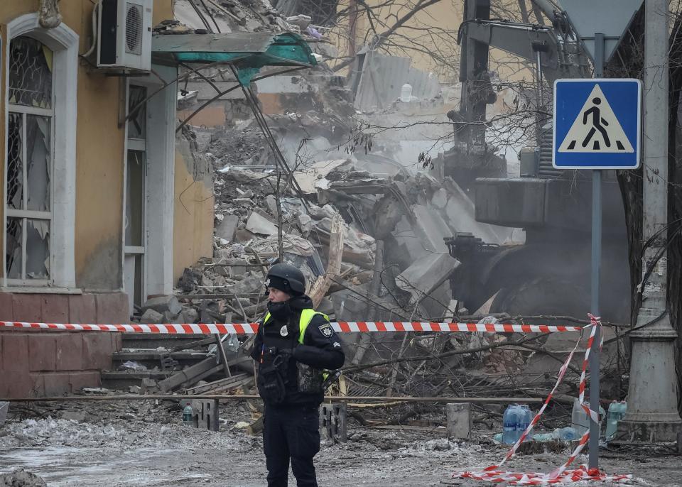 A police officer guards the site of a residential building destroyed in last night’s attack on Kramatorsk (Reuters)