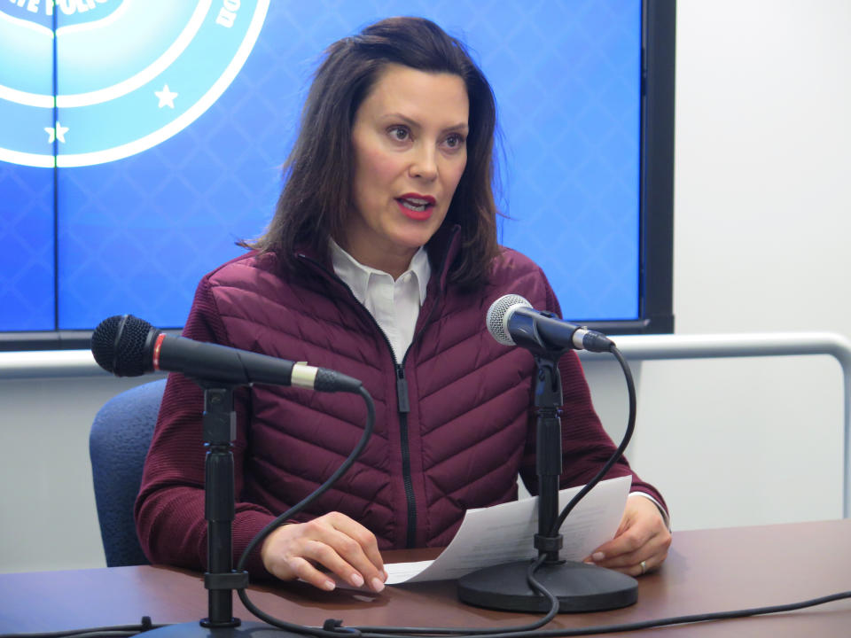 FILE - In this Tuesday, March 10, 2020, file photo, Michigan Gov. Gretchen Whitmer announces the state's first two cases of coronavirus, at the Michigan State Police headquarters in Windsor Township, Mich. Coronavirus cases in Michigan rose sharply late Thursday, March 12, 2020, as officials announced more cases, and as some K-12 schools began announcing closures while others began training staff to potentially move to online learning only. (AP Photo/David Eggert, File)