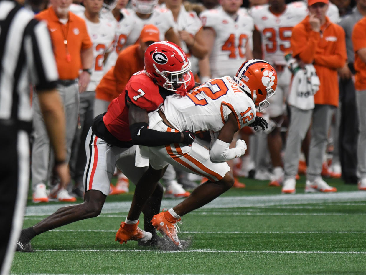 ATLANTA, GA - AUGUST 31: Georgia Bulldogs defensive back Daniel Harris (7) tackles Clemson Tigers wide receiver Bryant Wesco Jr. (12) during the AFLAC Kickoff Game between the Clemson Tigers and the Georgia Bulldogs on August 31, 2024, at Mercedes-Benz Stadium in Atlanta, Ga. (Photo by Jeffrey Vest/Icon Sportswire via Getty Images)