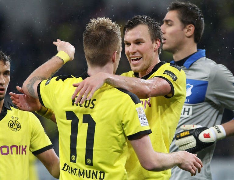 Dortmund's midfielder Kevin Grosskreutz (R) celebrates scoring the 2-1 with striker Marco Reus during the German first division Bundesliga football match against Hoffenheim in Sinsheim southwestern Germany, on December 16, 2012. Dortmund moved back up to third in the Bundesliga with a 3-1 win at strugglers Hoffenheim