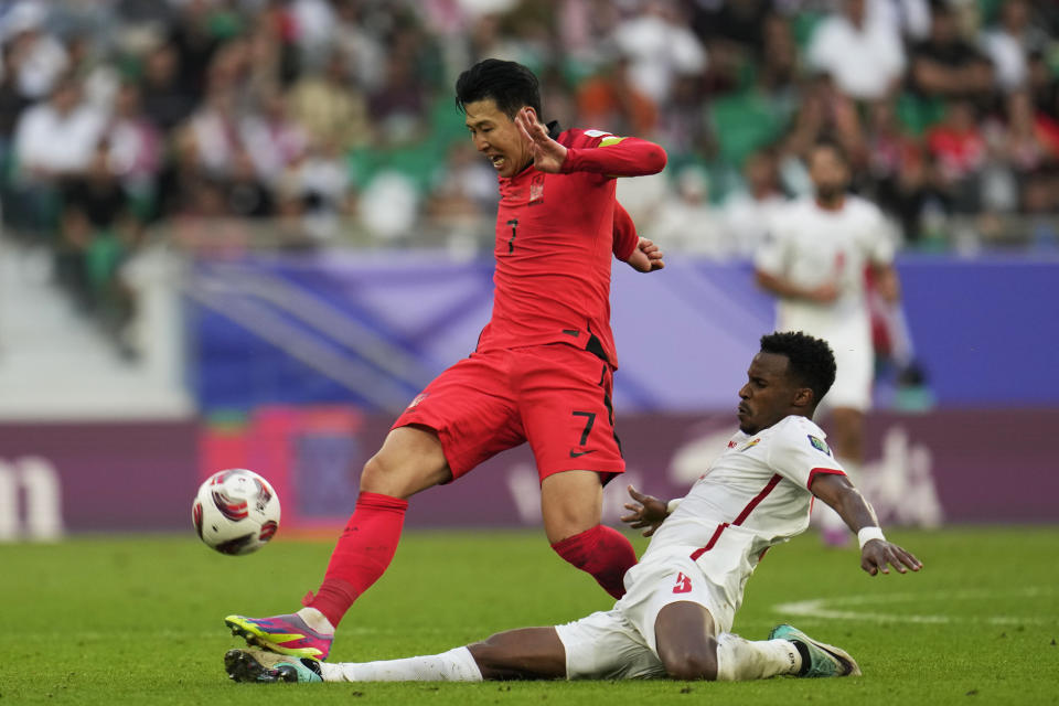 Jordan's Abdallah Nasib, bottom, stops South Korea's Son Heung-min during the Asian Cup Group E soccer match between Jordan and South Korea at Al Thumama in Doha, Qatar, Saturday, Jan. 20, 2024. (AP Photo/Aijaz Rahi)