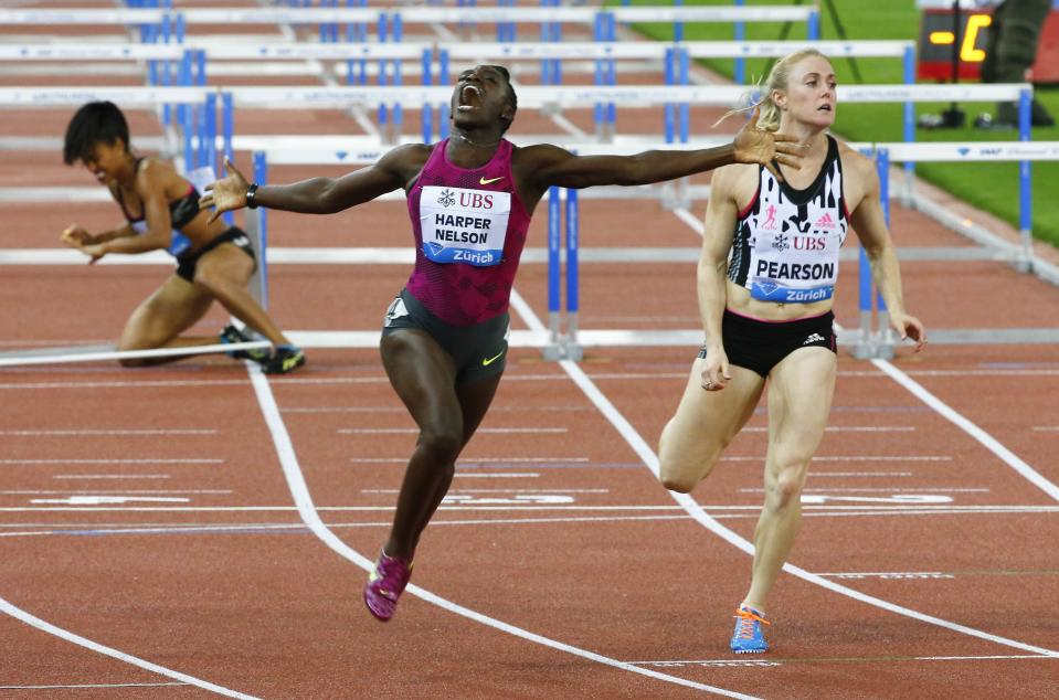 Dawn Harper-Nelson (C) of the U.S. celebrates winning the women's 100m hurdles event of the Weltklasse Diamond League meeting at the Letzigrund stadium in Zurich, in this August 28, 2014 file photo. REUTERS/Arnd Wiegmann/Files (SWITZERLAND - Tags: SPORT ATHLETICS TPX IMAGES OF THE DAY)