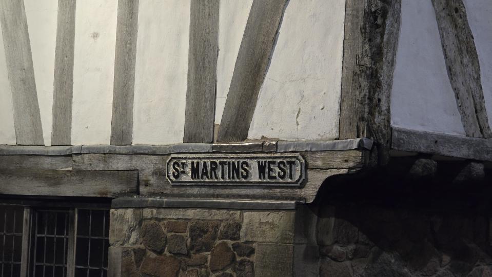 Close up of a street sign on a building