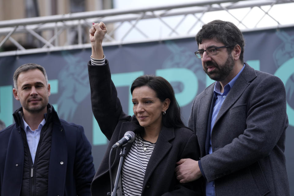 Marinika Tepic, center, a member of the Serbia Against Violence coalition, who is currently on hunger strike, raises her fist during a demonstration downtown Belgrade, Serbia, Saturday, Dec. 30, 2023. Thousands of people gathered to protest what election observers said were widespread vote irregularities during a recent general election. (AP Photo/Darko Vojinovic)