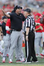 Ohio State head coach Ryan Day, left, questions a call by the referee during the first half of an NCAA college football game against Tulsa, Saturday, Sept. 18, 2021, in Columbus, Ohio. (AP Photo/Jay LaPrete)