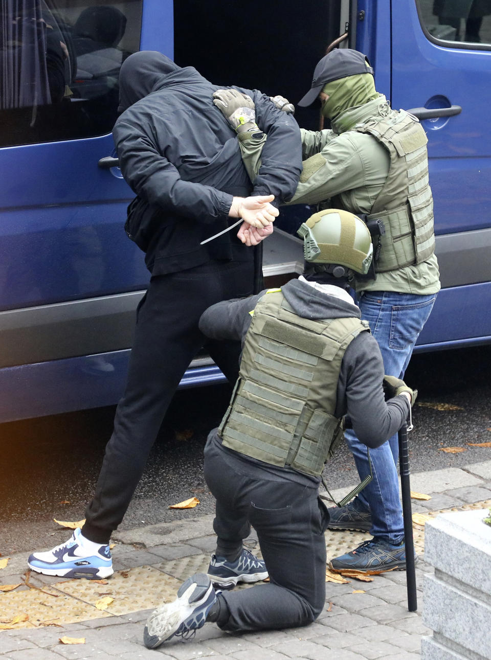 Police detain a man during an opposition rally to protest the official presidential election results in Minsk, Belarus, Sunday, Nov. 8, 2020. Club-swinging police went after demonstrators in the Belarusian capital who were demanding the resignation of the country's authoritarian president on Sunday, the 90th consecutive day of protests in the country. Human rights activists said nearly 400 people were arrested. (AP Photo)