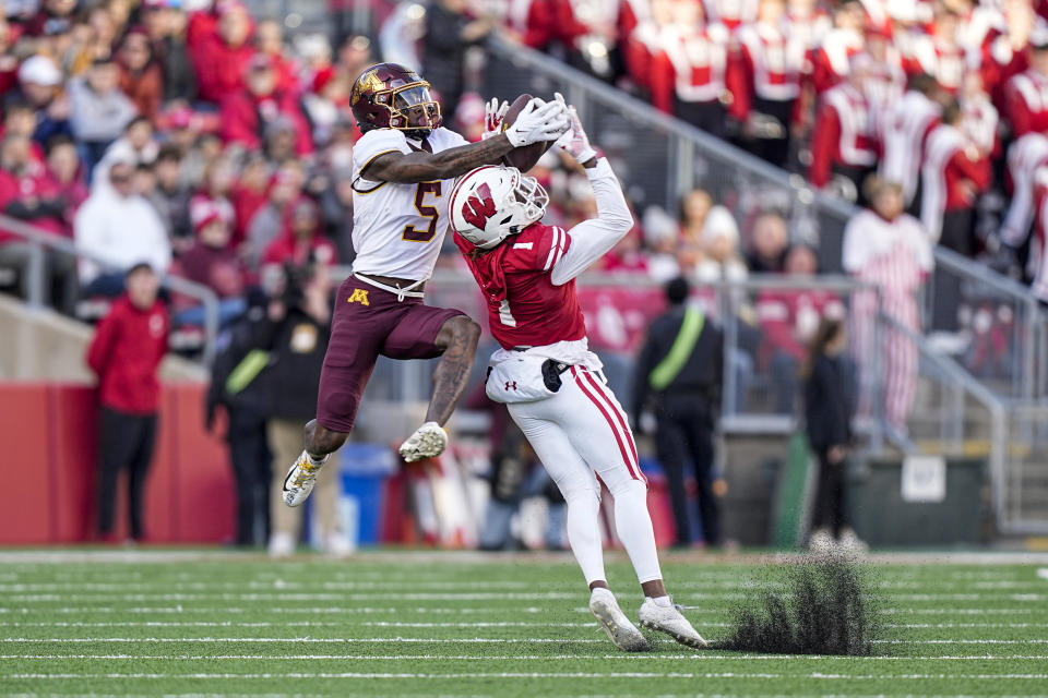 Minnesota wide receiver Dylan Wright (5) makes a reception over Wisconsin cornerback Jay Shaw (1) during the first half of an NCAA college football game Saturday, Nov. 26, 2022, in Madison, Wis. (AP Photo/Andy Manis)