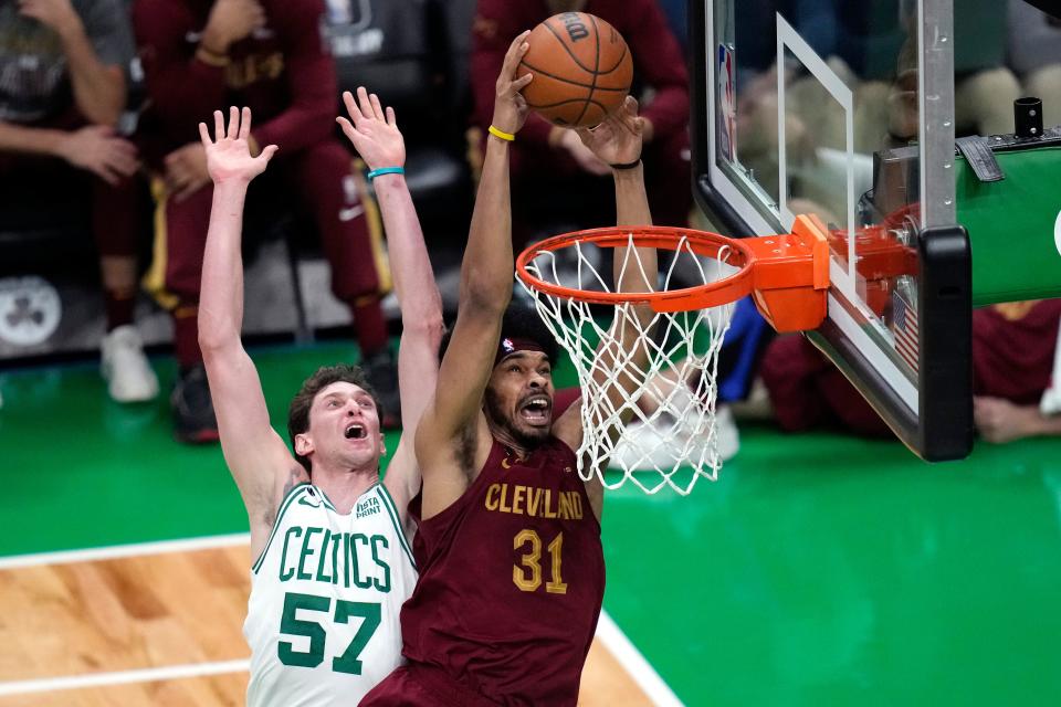 Cleveland Cavaliers center Jarrett Allen (31) lines up a dunk after driving past Boston Celtics forward Mike Muscala during the first half of an NBA basketball game, Wednesday, March 1, 2023, in Boston. Allen missed the shot. (AP Photo/Charles Krupa)