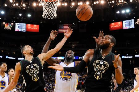 December 18, 2015; Oakland, CA, USA; Milwaukee Bucks guard Michael Carter-Williams (5) and center Greg Monroe (15) go after the basketball against Golden State Warriors forward Draymond Green (23) during the third quarter at Oracle Arena. The Warriors defeated the Bucks 121-112. Mandatory Credit: Kyle Terada-USA TODAY Sports