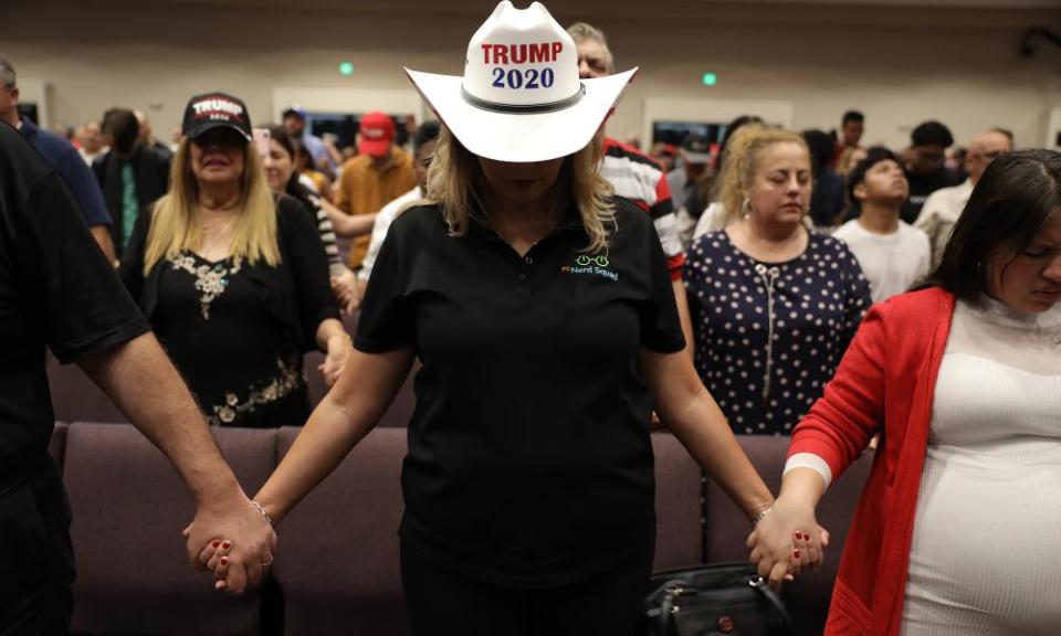 People pray together during the ‘Evangelicals for Trump’ campaign as they await the arrival of Donald Trump.