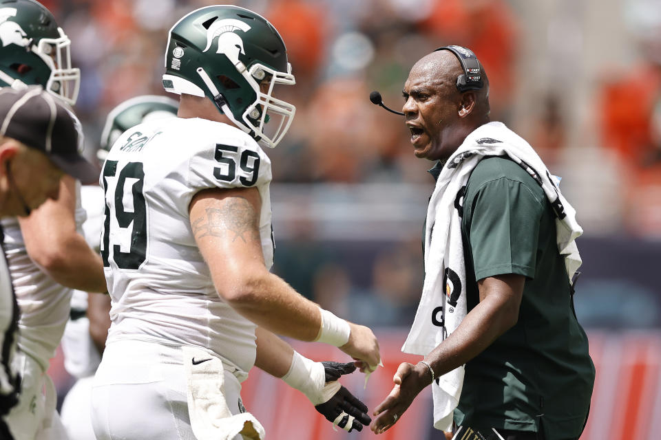 Michigan State head coach Mel Tucker celebrates with players after a field goal during the second quarter of an NCAA college football game against Miami, Saturday, Sept. 18, 2021, in Miami Gardens, Fla. (AP Photo/Michael Reaves)