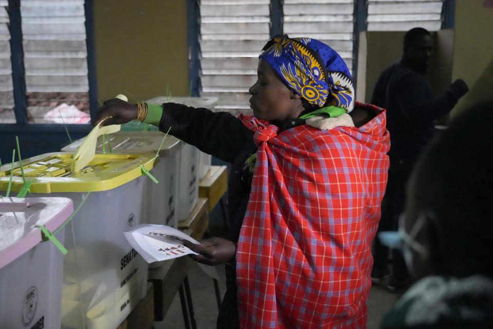 People line up to vote at the Moi avenue Primary School in Nairobi, Kenya, Tuesday, Aug. 9, 2022. Polls opened Tuesday in Kenya's unusual presidential election, where a longtime opposition leader who is backed by the outgoing president faces the deputy president who styles himself as the outsider. (AP Photo/Khalil Senosi)