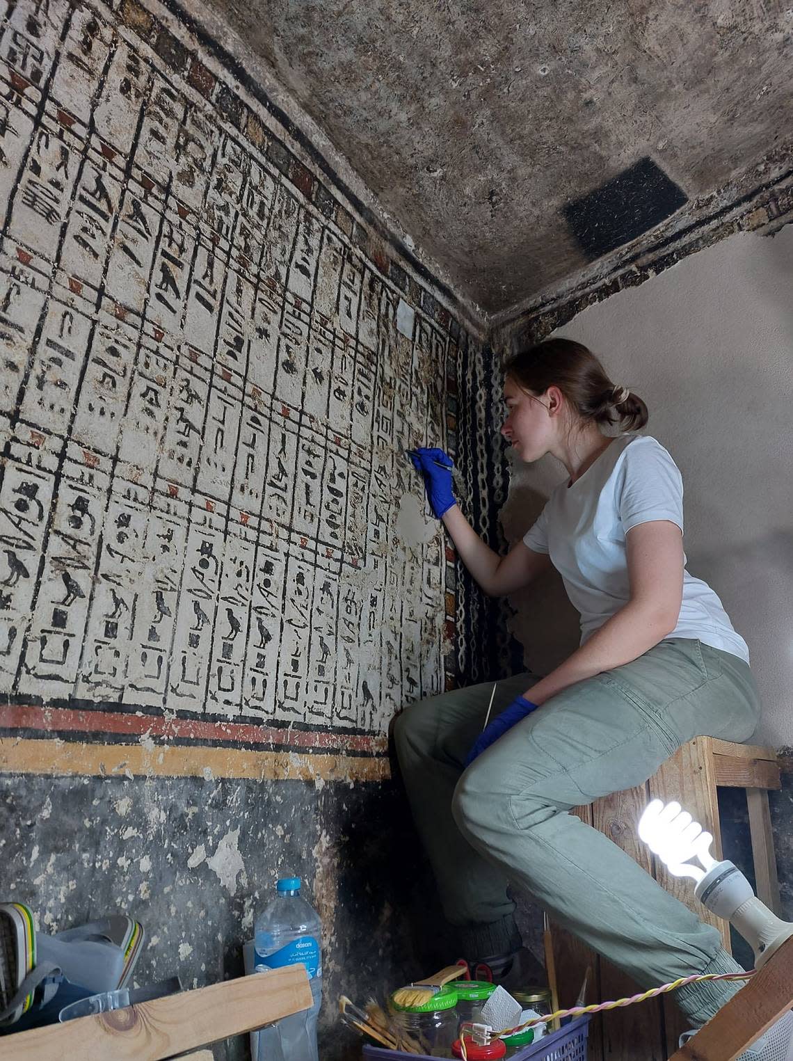 An archaeologists working on the paintings.