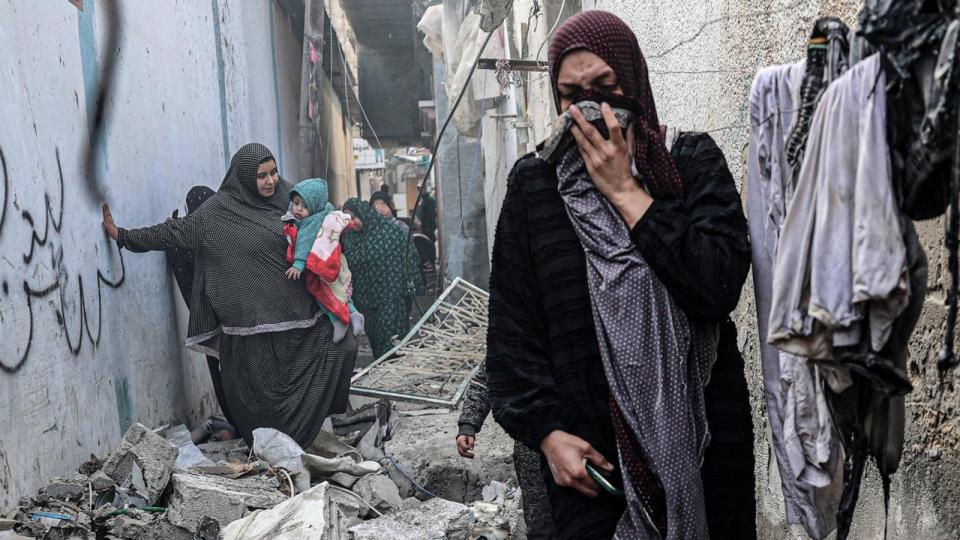 PHOTO: People find their way through a rubble-covered alley, following overnight Israeli bombardment in Rafah in the southern Gaza Strip, Feb. 25, 2024, amid continuing battles between Israel and the Palestinian militant group Hamas. (Said Khatib/AFP via Getty Images)