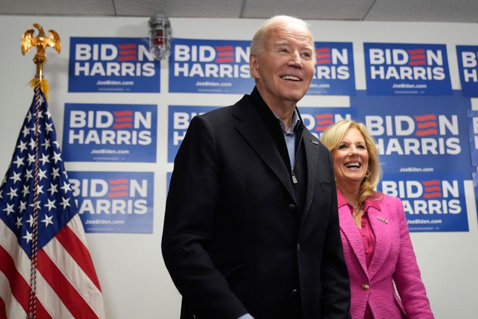 President Joe Biden, left, waits to speak as first lady Jill Biden looks on at the Biden campaign headquarters in Wilmington, Del., Saturday, Feb. 3, 2024.