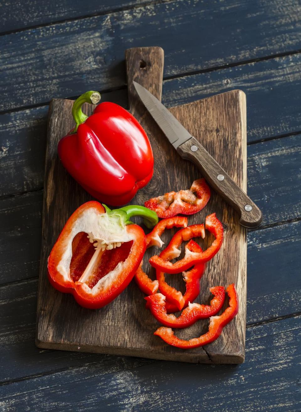 fresh red sweet pepper on a wooden rustic board