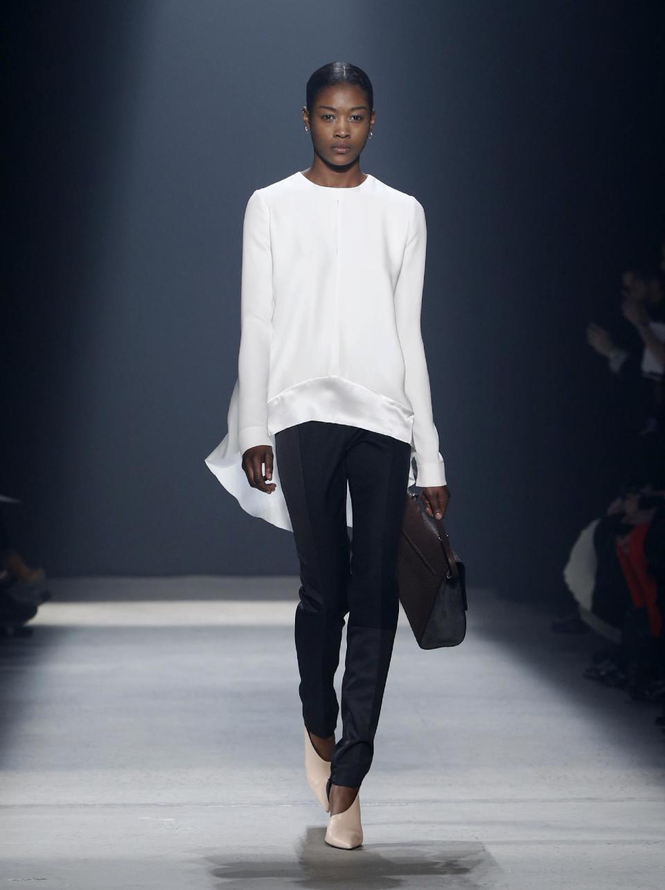 A model walks the runway during the showing of the Narciso Rodriguez Fall 2014 collection at Fashion Week in New York, Tuesday, Feb. 11, 2014. (AP Photo/Kathy Willens)