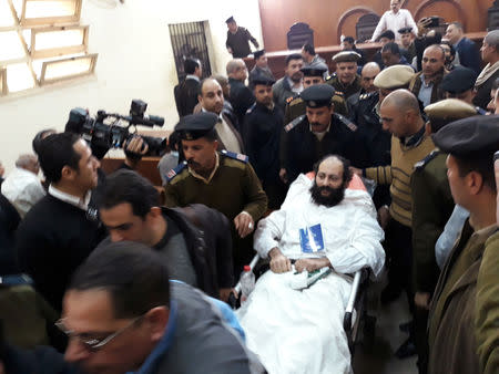 Ramon Rasmi Mansour, known as Faltaous al-Makari, lies on a stretcher after his and monk Isaiah's (not seen) trial session, at the courthouse in a courtroom where he was convicted along with Wael Saad, known as Isaiah al-Makari, of murdering Bishop Epiphanius, the abbot of Saint Macarius Monastery northwest of Cairo, in Damanhour, Egypt February 23, 2019. REUTERS/Ahmed Fahmy