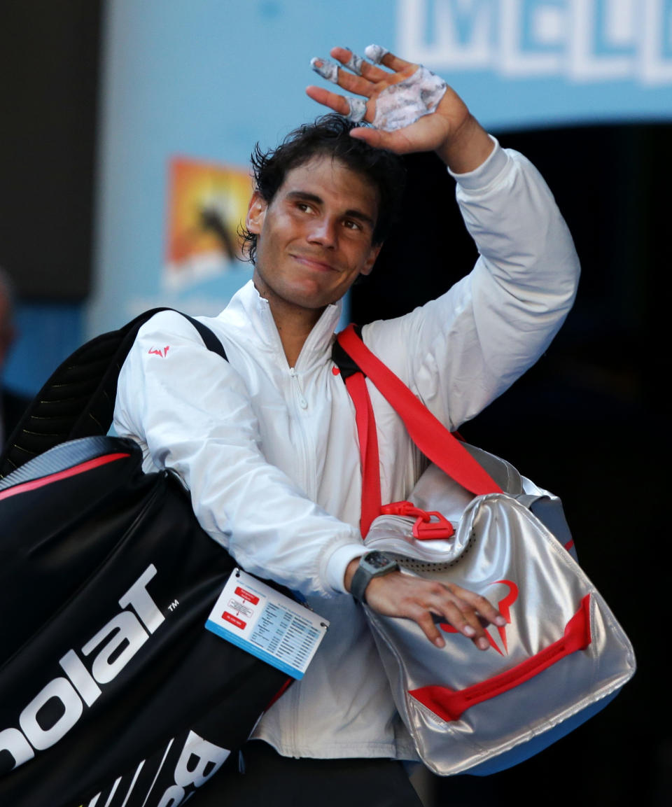 Rafael Nadal of Spain walks off the court after defeating Grigor Dimitrov of Bulgaria in their quarterfinal at the Australian Open tennis championship in Melbourne, Australia, Wednesday, Jan. 22, 2014.(AP Photo/Aaron Favila)