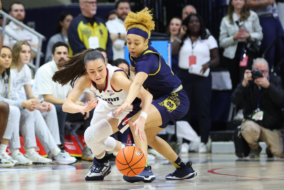 STORRS, CT - JANUARY 27: UConn Huskies guard Nika Muhl (10) and Notre Dame Fighting Irish guard Hannah Hidalgo (3) battle for the loose ball during the women's college basketball game between Notre Dame Fighting Irish and UConn Huskies on January 27, 2024, at Harry A. Gampel Pavilion in Storrs, CT. (Photo by M. Anthony Nesmith/Icon Sportswire via Getty Images)