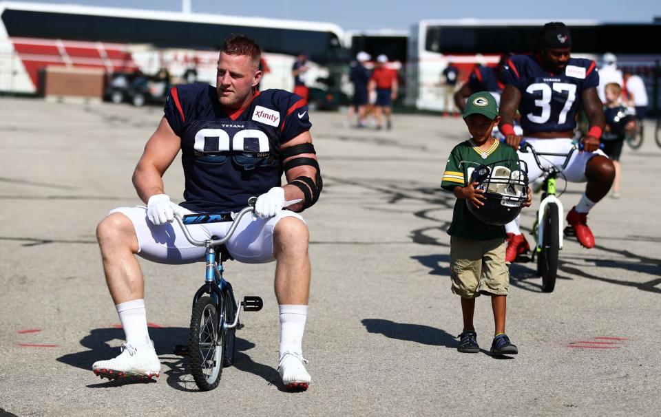 Wisconsin native J.J. Watt briefly rode a tiny bike to a Texans-Packers joint practice - until he broke the seat of the bike. (Packers/Twitter)