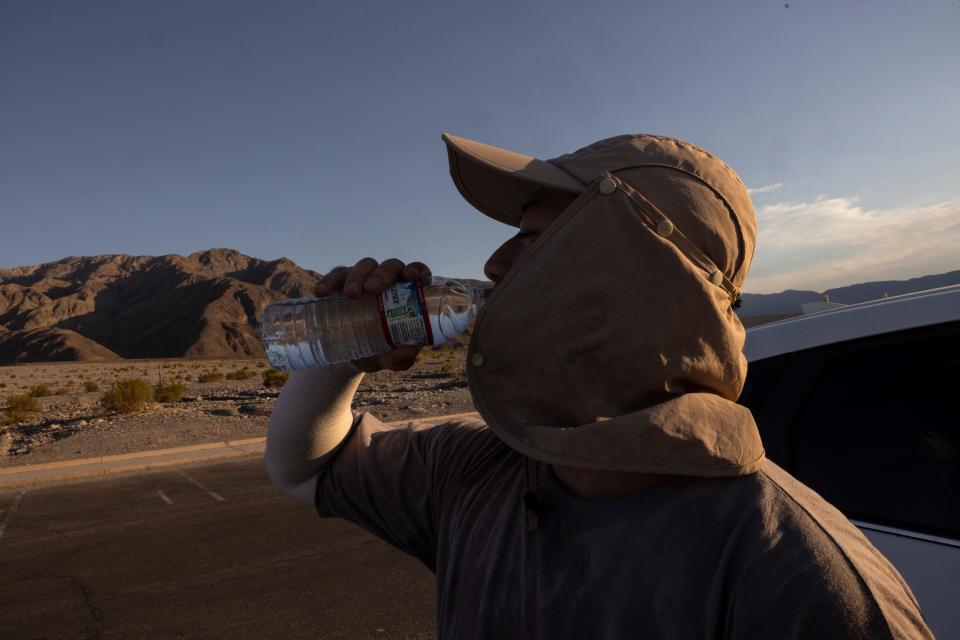 A tourist drinks water as he hikes in the Mesquite Flat Sand Dunes in Death Valley National Park, near Furnace Creek, during a heat wave impacting Southern California on July 7, 2024.