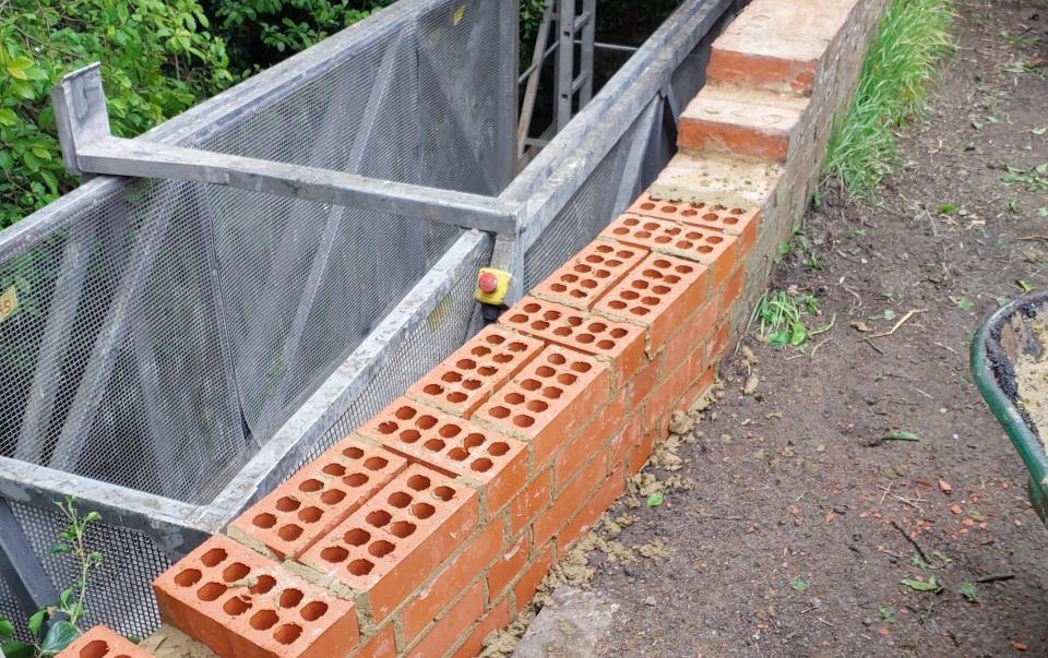 The council cleared vegetation around the bridge and repaired it after bricks fell into the river