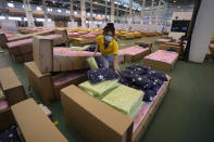 A worker prepares a 1,800-bed field hospital set up inside a cargo building in Don Mueang International Airport in Bangkok, Thailand, Thursday, July 29, 2021. Health authorities raced on Thursday to set up yet another large field hospital in Thailand's capital as the country recorded a new high in COVID-19 cases and deaths. The hospital, one of many already in use, was being set up at one of Bangkok's two international airports after the capital ran out of hospital beds for thousands of infected residents. (AP Photo/Sakchai Lalit)