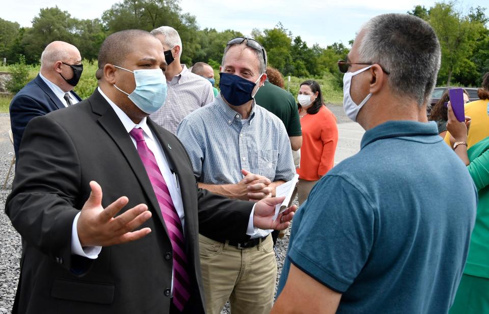 New York State Conservationist for the USDA Blake Glover, left, talks with Ron Loubier, right, a homeowner who was hit hard during the 2019 Halloween flooding event. Glover was among many local, state and federal officials who relayed the news in early September that $20 million in federal funding will be available to assist eligible homeowners in Whitesboro and Whitestown who were affected by flooding along the Sauquoit Creek.