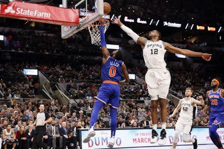 Mar 15, 2019; San Antonio, TX, USA; New York Knicks shooting guard Kadeem Allen (0) shoots the ball past San Antonio Spurs power forward LaMarcus Aldridge (12) during the second half at AT&T Center. Mandatory Credit: Soobum Im-USA TODAY Sports