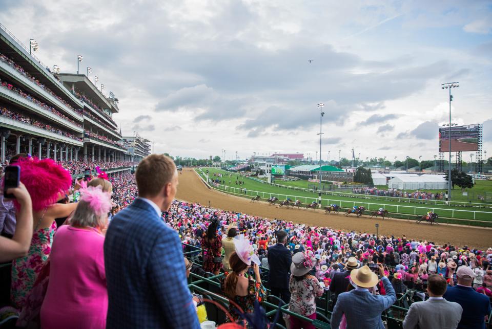 A crowd watches the Oaks race at Churchill Downs in Louisville, Ky on May 6, 2022. 