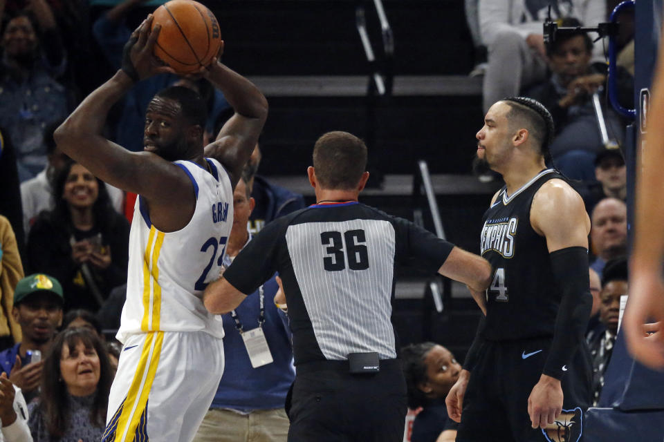 Mar 9, 2023;  Memphis, Tennessee, USA;  Golden State Warriors forward Draymond Green (23) and Memphis Grizzlies forward Dillon Brooks (24) are separated by an official after a basket by Brooks during the first half at FedExForum.  Mandatory Credit: Petre Thomas-USA TODAY Sports