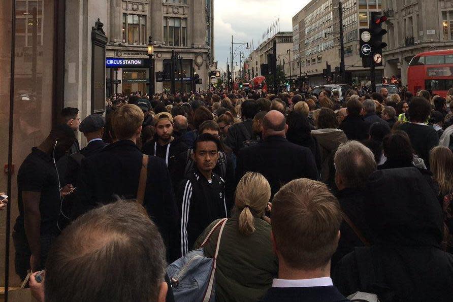 Delays: Crowds outside Oxford Circus station after the Victoria Line was suspended: @KrisIngham1