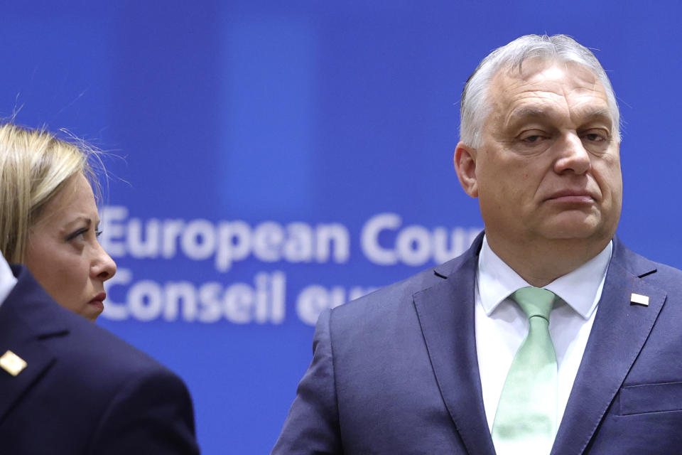 Hungary's Prime Minister Viktor Orban, right, and Italy's Prime Minister Giorgia Meloni attend a round table meeting at an EU summit in Brussels, Thursday, March 23, 2023. European Union leaders meet Thursday for a two-day summit to discuss the latest developments in Ukraine, the economy, energy and other topics including migration. (AP Photo/Olivier Matthys)