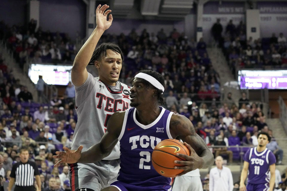 TCU forward Emanuel Miller (2) works against Texas Tech guard Darrion Williams, rear, for a shot opportunity in the first half of an NCAA college basketball game in Fort Worth, Texas, Tuesday, Jan. 30, 2024. (AP Photo/Tony Gutierrez)