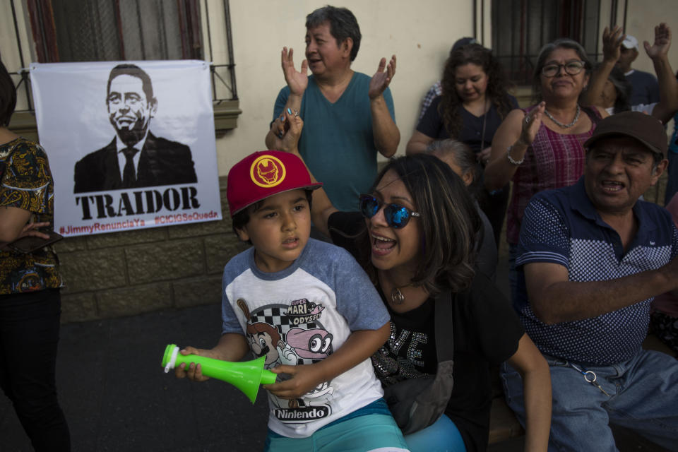 Demonstrators protest against Guatemalan President Jimmy Morales during a demonstration organized by civil society groups in front of the Presidential House in Guatemala City, Saturday, July 27, 2019. (AP Photo/ Oliver de Ros)