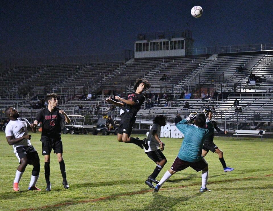 Palm Beach Central forward Luis Dominquez tries a header toward goal during the first half of Friday's 8-0 victory against Palm Beach Lakes.